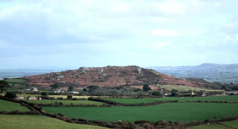 Trencrom Hill, with Carn Brea behind, as seen from near Castle an Dinas